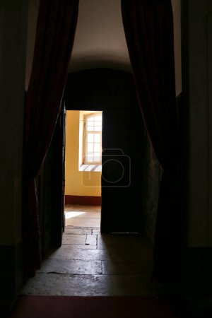 Corridor with curtain and sun coming through the window in the background