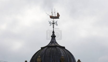 Photo for Bristol, England- March 30, 2024: Weather vane on the tower dome of Watershed building, antique transit sheds building, now a cross-artform venue in Bristol Harbourside - Royalty Free Image