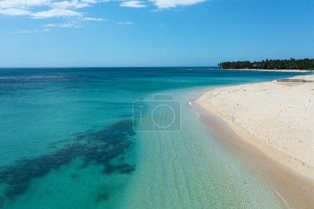 Foto de A tropical beach with palm trees and a blue ocean. Pagudpud, Ilocos Norte Philippines - Imagen libre de derechos