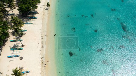 Foto de Aerial view of sandy beach with palm trees and ocean surf with waves. Pagudpud, Ilocos Norte Philippines - Imagen libre de derechos