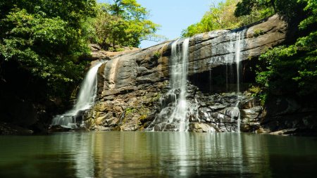 Beautiful waterfall in green forest. Tropical Sera ella Falls in mountain jungle, Sri Lanka.