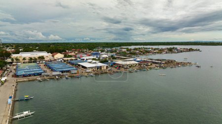 Photo for Aerial view of town on the seashore with a pier and boats. Bantayan Island. Philippines. - Royalty Free Image