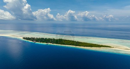 Aerial view of Mataking island on a coral reef or atoll with a sandy beach. Tropical landscape.Tun Sakaran Marine Park. Borneo, Sabah, Malaysia.