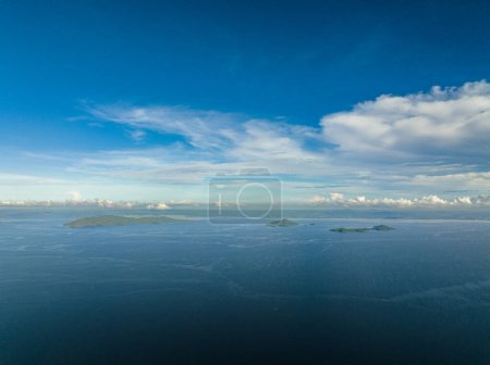 Tropical islands in the blue sea against the background of the sky and clouds. Philippines.