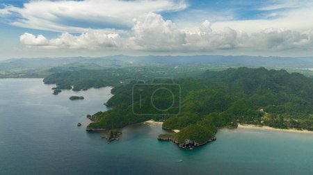 Téléchargez les photos : Aerial view of coast of the island with tropical vegetation and the beach. Negros, Philippines. - en image libre de droit