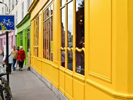 Photo for Paris France - June 21 2009; Colourful shop fronts along city street Quai de Valmy. - Royalty Free Image