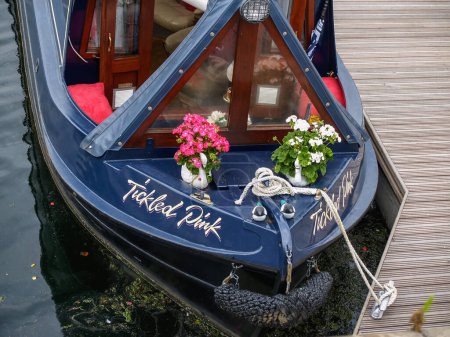 Photo for Liverpool United Kingdom - June 30 2009; Foredeck and bow of moored boat names Tickled pink with potted flowers - Royalty Free Image