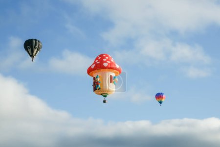 Foto de Hamilton New Zealand March 27 2010; Hot air balloons in fun designs flying high - Imagen libre de derechos