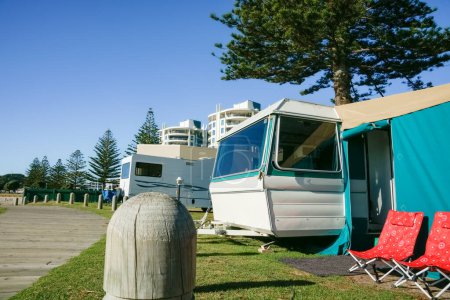 Photo for Summer holiday caravans parked under Norfolk Pine tree with outdoors seats. - Royalty Free Image