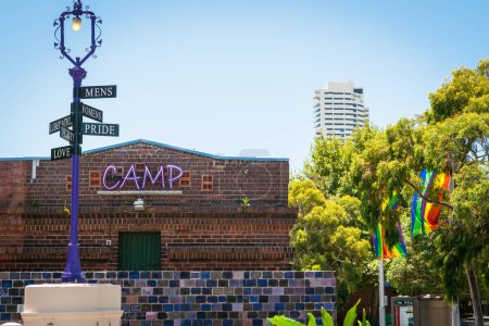 Photo for Sydney Australia - January 26 2011; Sign post promoting rainbow community in front of neon sign saying CAMP - Royalty Free Image