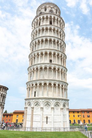 Photo for Pisa Italy - April 24 2011; Editorial-Tourists in square around famous Leaning Tower of Pisa from below towering upwards. - Royalty Free Image
