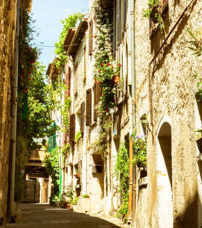 Photo for Old style image three story building lining narrow typically Mediterranean residential lane, Saint Paul de Vence, Provence, France. - Royalty Free Image
