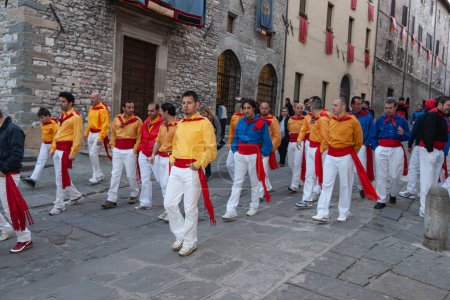 Photo for Gubbio Umbria, Italy-May 15 2011; People dressed in traditional uniform walk in street towards celebration event. - Royalty Free Image
