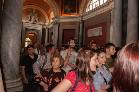 Photo for Rome Italy - May 22 2011; Tourists packed together in crowd moving through Vatican gallery. - Royalty Free Image