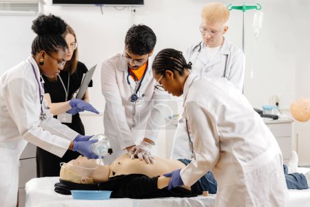 A team of medical professionals is gathered around a patient, diligently performing a medical procedure in a clinical setting.