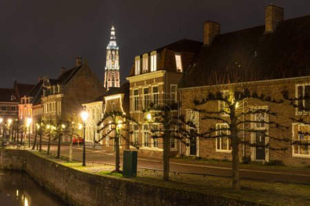 Photo for Dutch city Amersfoort at night, picturesque street with a view on late gothic church known as Lange Jan - Royalty Free Image