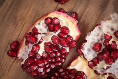 Photo for Fresh, ripe pomegranate on a wooden background. - Royalty Free Image
