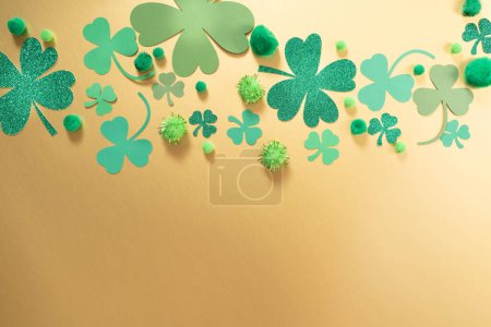 St. Patricks Day themed gold background with shamrock clover of various sizes and shades of green.