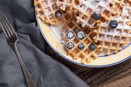Photo for Waffles, blueberries, and powdered sugar. - Royalty Free Image