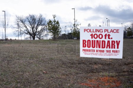 Red and white polling place 100ft. boundary sign.