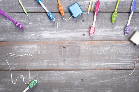 Colorful toothbrush, gum brush, and dental floss background.  Dental health, care, hygiene awareness.