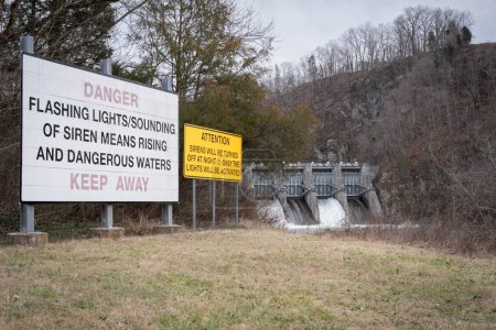 Foto de Señal de advertencia frente a la presa de Fort Patrick Henry, ubicada en el condado de Sullivan en Kingsport, Tennessee, en el río South Fork Holston. Peligro, aléjate.. - Imagen libre de derechos