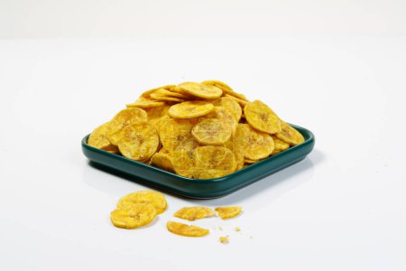 Photo for Kerala chips or Banana chips, cult snack item of Kerala, arranged in a green ceramic square shaped plate ,Isolated image with white background - Royalty Free Image