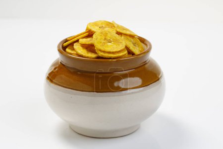 Photo for Kerala chips or Banana chips, cult snack item of Kerala, arranged traditionally in ceramic pot ,bharani,Isolated image with white background - Royalty Free Image