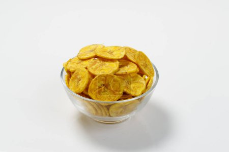 Photo for Kerala chips or Banana chips, cult snack item of Kerala,arranged in  atransparent bowl;Isolated image with white background - Royalty Free Image