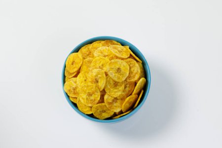 Photo for Kerala chips or Banana chips, cult snack item of Kerala,arranged in a pastle colour ceramic bowl,Isolated image with white background - Royalty Free Image