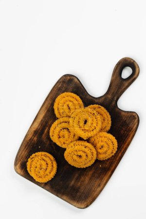 Photo for MURUKKU, Kerala  special snack made using rice flour, isolated image arranged in white background. - Royalty Free Image