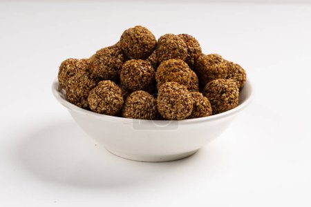 Photo for Sesame Ladoo or Ellu unda or Til ladoo, a traditional Indian sweet treat made from sesame seeds and jaggery,isolated image with white background. - Royalty Free Image