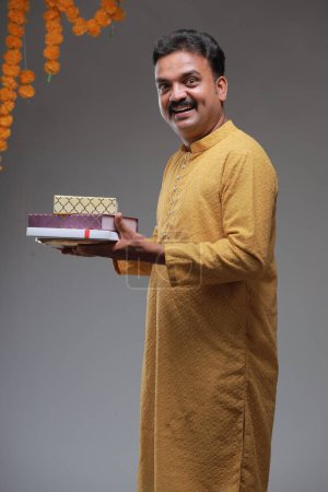 Foto de Un hombre con traje tradicional indio, con fondo liso, aislado, con kurta amarilla y pijama blanco. - Imagen libre de derechos