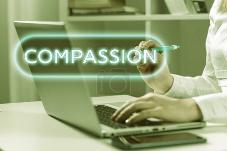 Photo for Text showing inspiration Compassion, Concept meaning empathy and concern for the pain or misfortune of others Woman Typing Updates On Lap Top And Pointing New Ideas With Pen. - Royalty Free Image