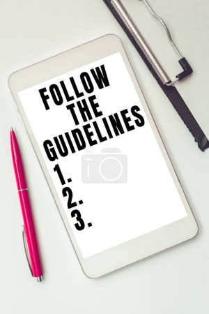 Photo for Hand writing sign Follow The Guidelines, Business idea Pay attention to general rule, principles or advice - Royalty Free Image