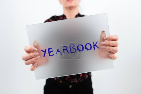 Photo for Text caption presenting Yearbook, Business showcase publication compiled by graduating class as a record of the years activities - Royalty Free Image