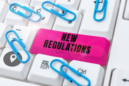 Foto de Texto que presenta nuevos reglamentos, Visión general de las empresas Regulación que controla la actividad habitualmente utilizada por las normas. - Imagen libre de derechos