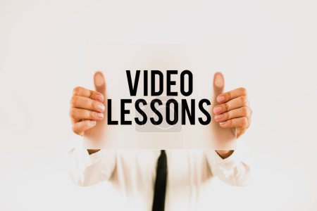 Foto de Text caption presenting Video Lessons, Word Written on Online Education material for a topic Viewing and learning - Imagen libre de derechos