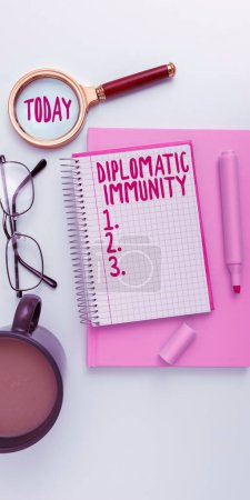 Photo for Hand writing sign Diplomatic Immunity, Word for law that gives foreign diplomats special rights in the country they are working - Royalty Free Image
