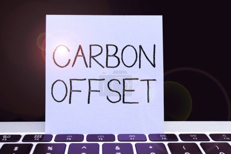 Photo for Text sign showing Carbon Offset, Business overview Reduction in emissions of carbon dioxide or other gases - Royalty Free Image