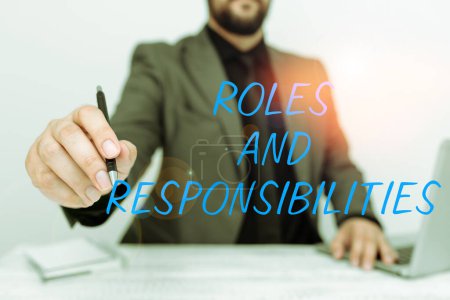 Photo for Text sign showing Roles And Responsibilities, Business concept Business functions and professional duties - Royalty Free Image