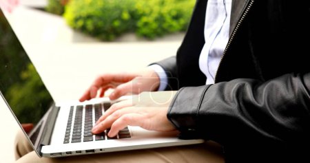 Photo for Close-up male hands typing on laptop, man freelancer sitting and working remotely outdoors, student using computer technology to study or work online. - Royalty Free Image