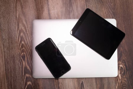Photo for Devices with blank screens on wooden background - Royalty Free Image