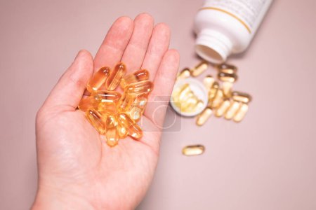Photo for Oil filled capsules of food supplements: fish oil, omega 3, omega 6, omega 9, vitamin A, vitamin D3, vitamin E, borage oil. - Royalty Free Image