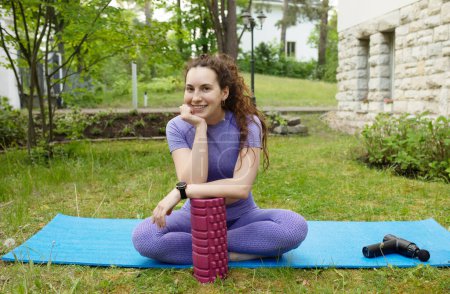 Photo for Young fit woman meditating outdoor. Girl in sportswear exercising outside. - Royalty Free Image