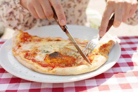 Photo for Cutting pizza into pieces. Woman cutting pizza close-up. - Royalty Free Image