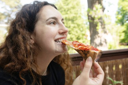 Photo for Beautiful young woman eating delicious pizza. - Royalty Free Image