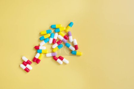 Photo for Colorful capsules on yellow background - Royalty Free Image