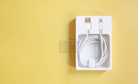 Photo for White electric power cable on yellow background, copy space - Royalty Free Image