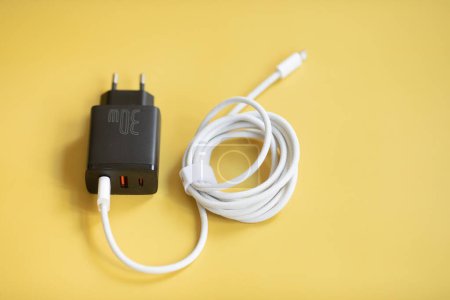 Photo for Charger on yellow background with copy space. - Royalty Free Image